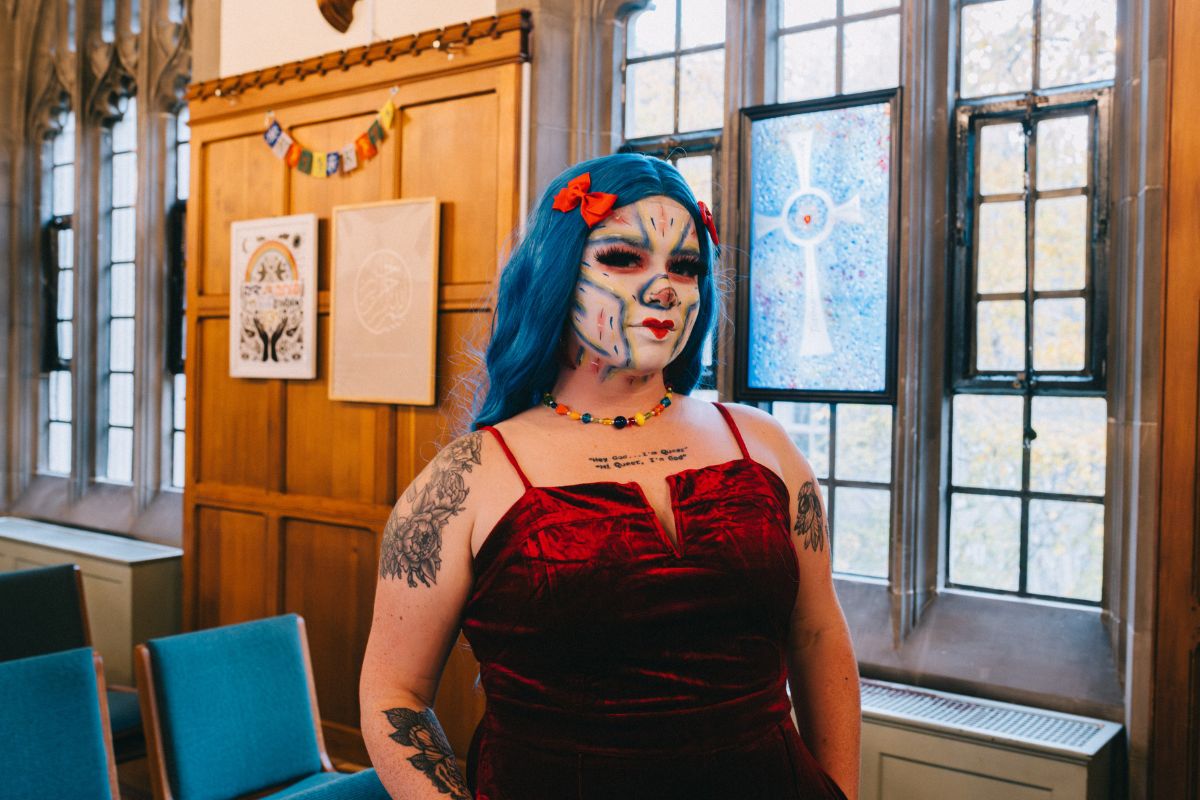 Julian Munro, an MDiv/MPS student at Emmanuel who co-directed the summit, stands in Emmanuel Chapel as their drag persona King Julez.